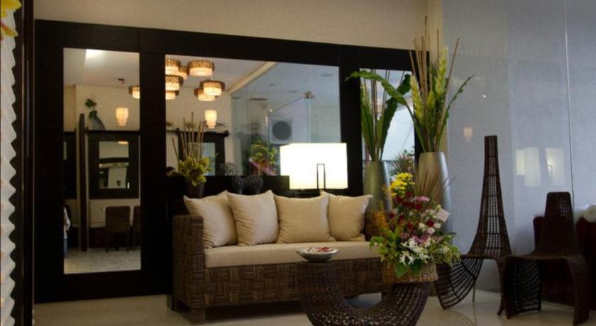 a living room filled with furniture and flowers, Hotel Stella in Cebu