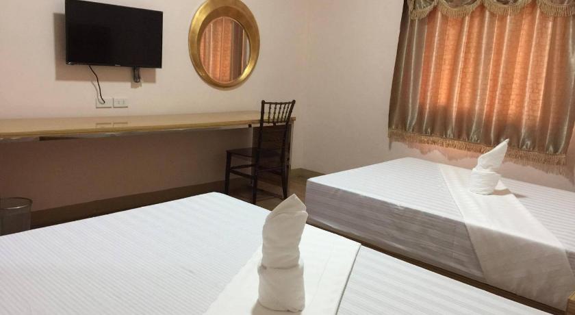 a hotel room with a bed and a television, Meaco Royal Hotel - Lipa in Batangas