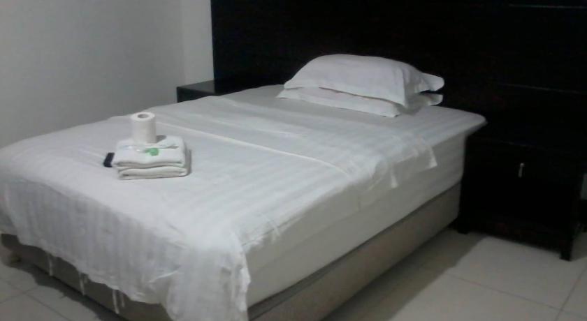 a hotel room with a white bedspread and white sheets, Asia Novo Boutique Hotel-Roxas City in Roxas City (Capiz)