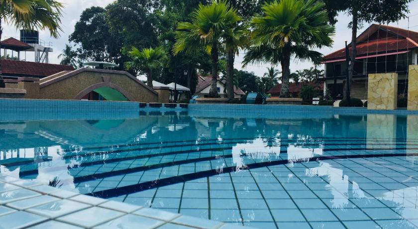 a swimming pool filled with lots of water next to a building, De Palma Resort Kuala Selangor in Kuala Selangor