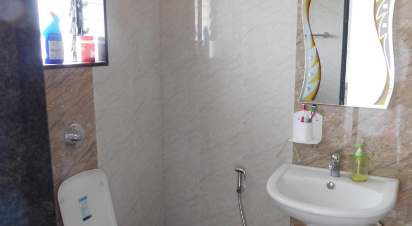 a bathroom with a toilet, sink, and mirror, HemPriya - 2BHK wit a Private Pool in Lonavala