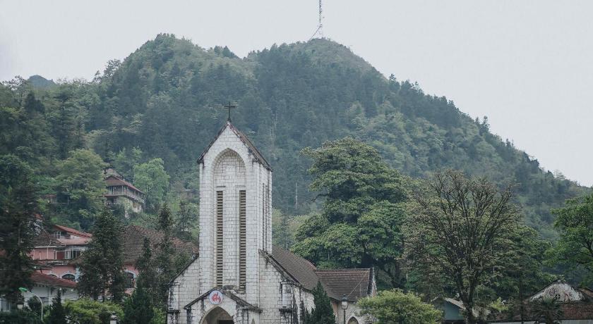 a church steeple with a clock tower on top of it, My Dream Hotel in Sapa
