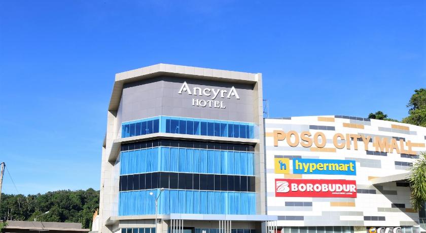 a large building with a clock on the front of it, Ancyra by Continent Hotel Poso in Poso