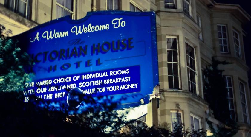 a blue and white sign on a building, Victorian House Hotel in Glasgow