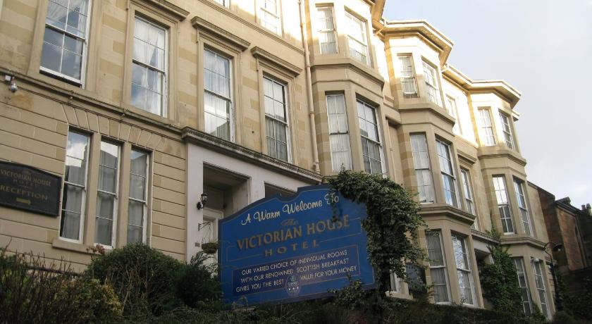 a large building with a sign on the side of it, Victorian House Hotel in Glasgow