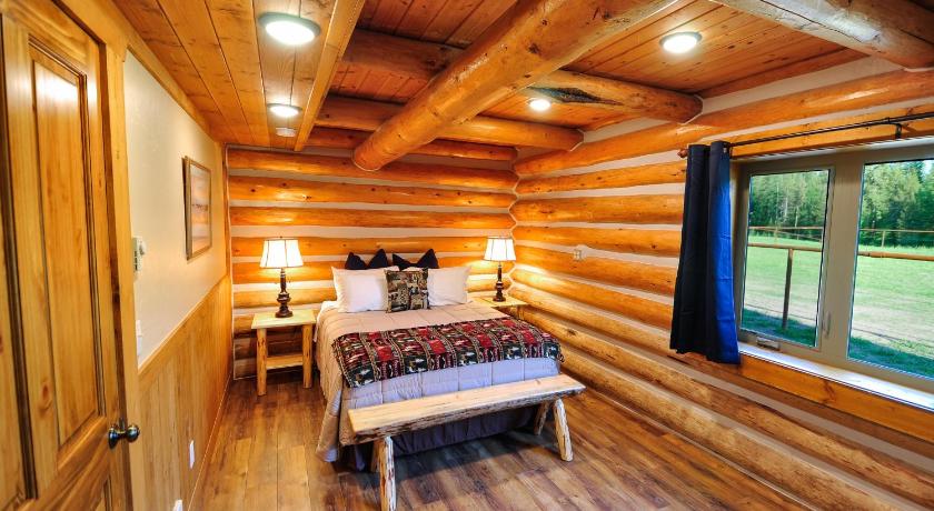 a bed room with a wooden floor and a large window, Paddle Ridge in West Glacier (MT)