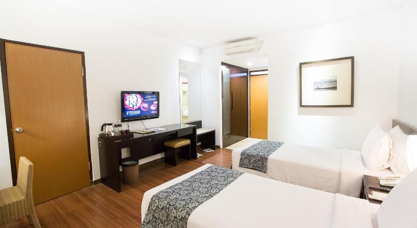 a hotel room with a bed and a television, Gumilang Regency Hotel by Gumilang Hospitality in Bandung