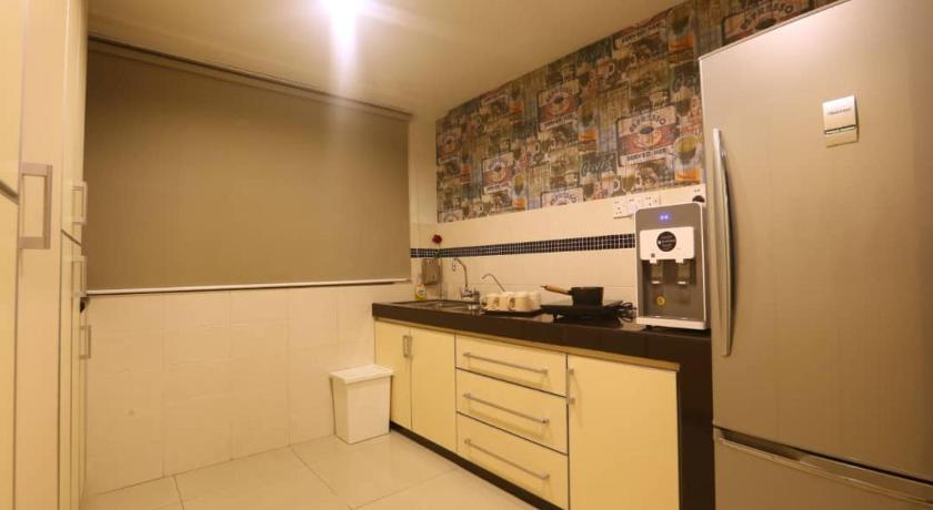 a kitchen with a refrigerator, sink, and microwave, Platinum Homestay in Kuala Lumpur
