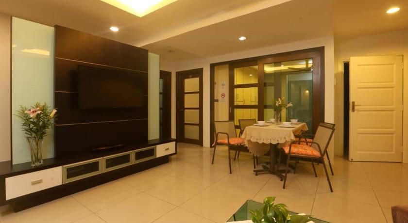 a living room filled with furniture and a tv, Platinum Homestay in Kuala Lumpur
