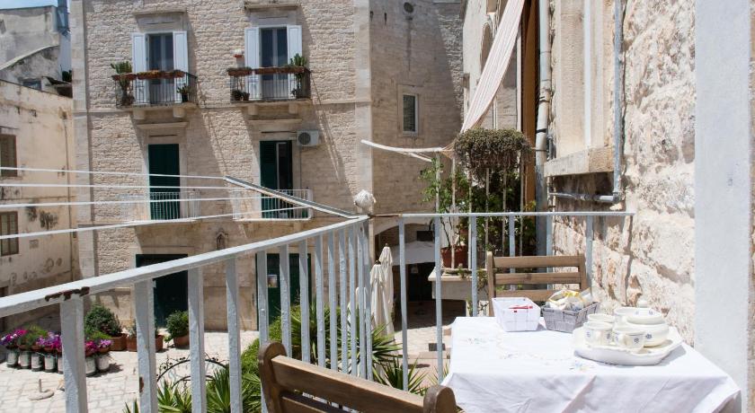 a house with a balcony overlooking a city, Casa Bianca in Giovinazzo