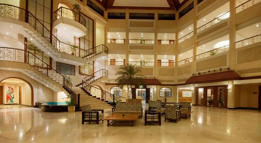 a large lobby filled with lots of tables and chairs, Lagoona Resort in Lonavala
