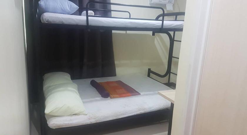 a bedroom with a bunk bed and a window, Haus Of Tubo Travellers Inn in Davao City