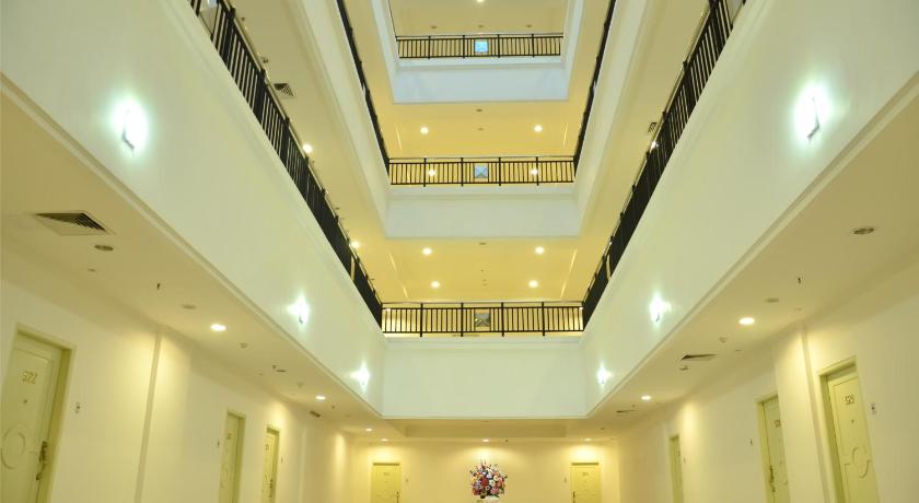 a large room with a large clock on the wall, MTC Mega Mas Apartment in Manado
