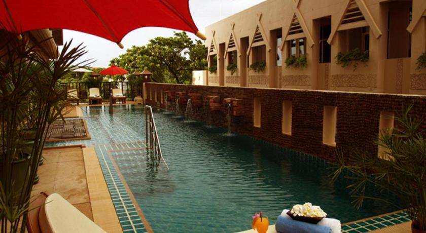 a patio area with umbrellas and a fountain, Maninarakorn Hotel (SHA Plus+) in Chiang Mai