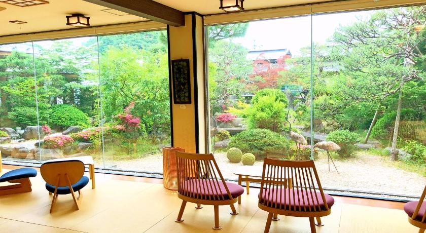 two chairs and a table in a room, Hohoemino Kuyufu Tsuruya Ryokan in Yamagata