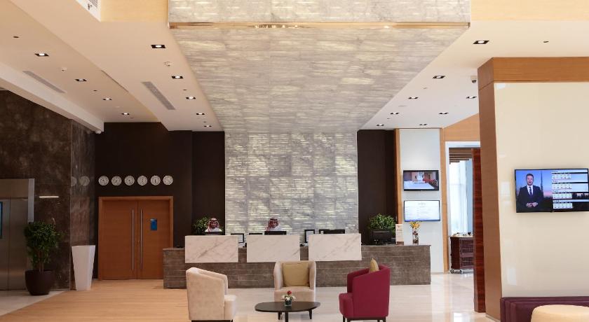 a living room filled with furniture and a large window, Novotel Jazan Hotel in Jazan