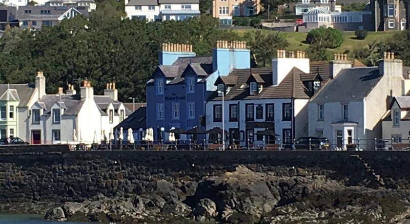 a small town with houses and boats on the water, The Waterfront Seafront hotel and Bistro in Portpatrick