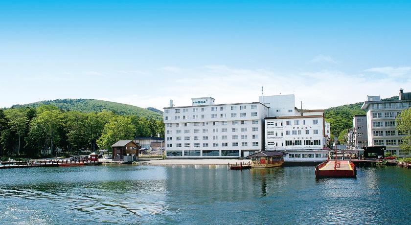 a large body of water with a large building, Hotel Gozensui in Kushiro