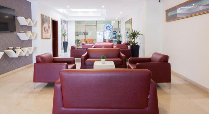 a living room filled with couches and chairs, St Sliema Hotel in Sliema