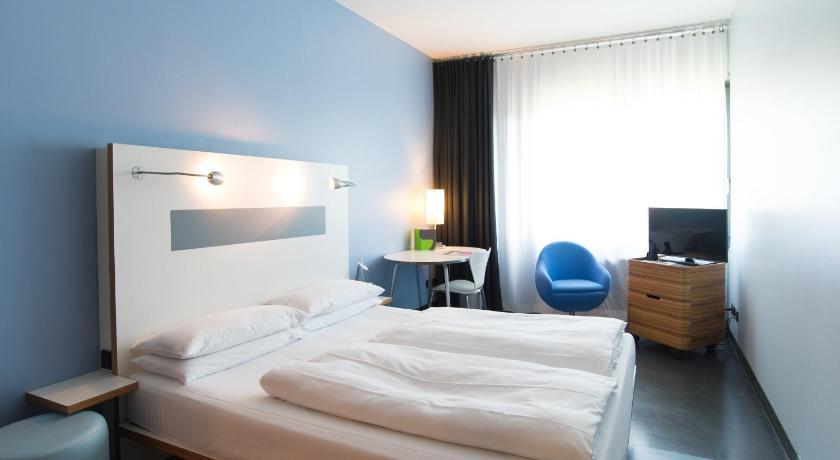 a hotel room with two beds and a television, Hotel Ku'Damm 101 in Berlin