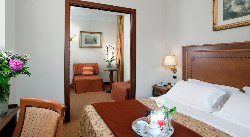a hotel room with a bed and a table, Pinewood Rome Hotel in Rome