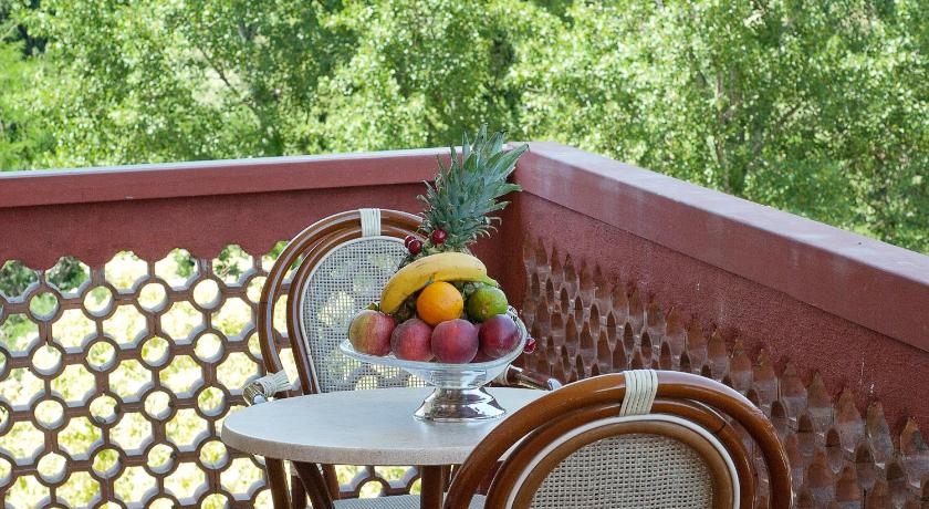 a table topped with a basket filled with fruit, Pinewood Rome Hotel in Rome