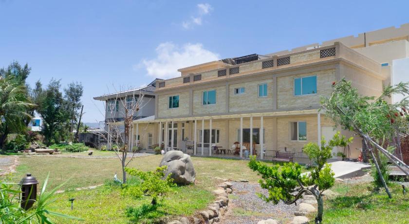 a large building with trees and houses, pisces in Kenting