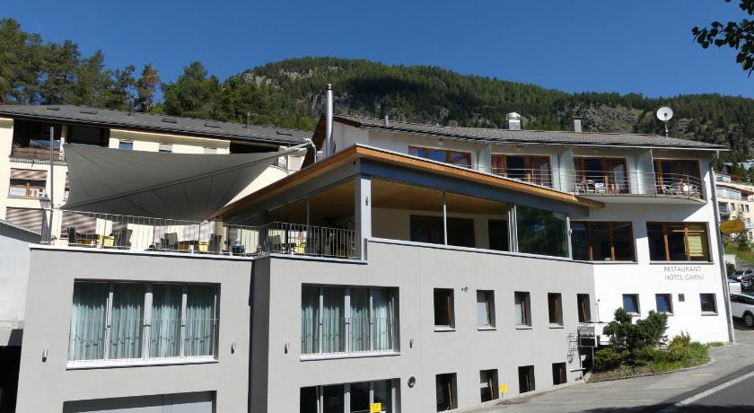 a large building with a large window on top of it, Laagers Hotel Garni in Samedan