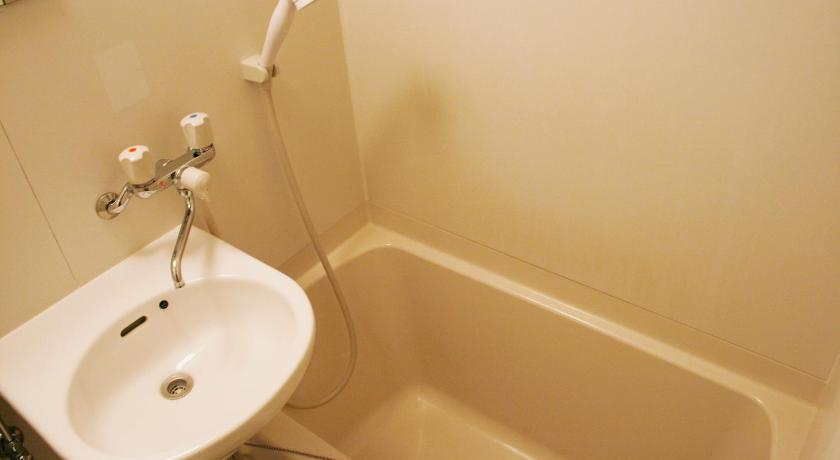 a bathroom with a sink, toilet and bathtub, Hotel Peace (Adult Only) in Tokyo