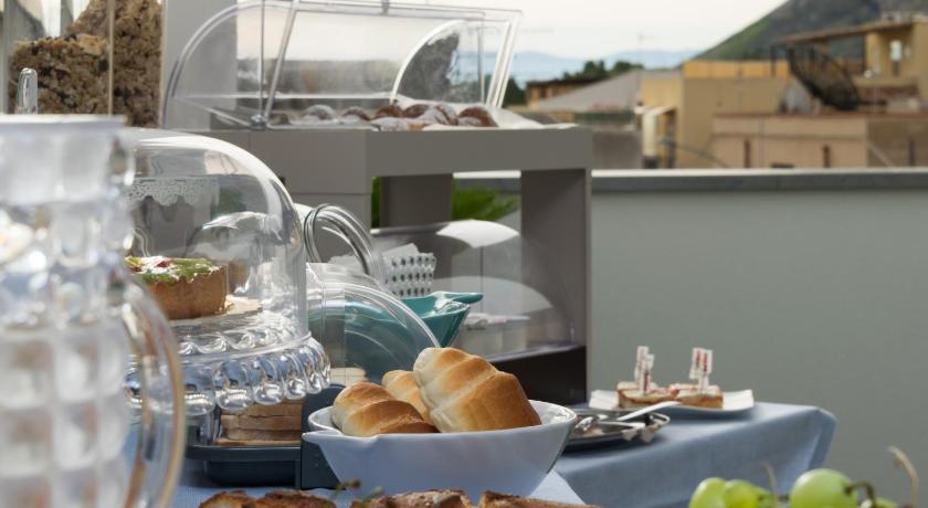 a table topped with plates of food and drinks, B&B Acqua Azzurra in San Vito Lo Capo