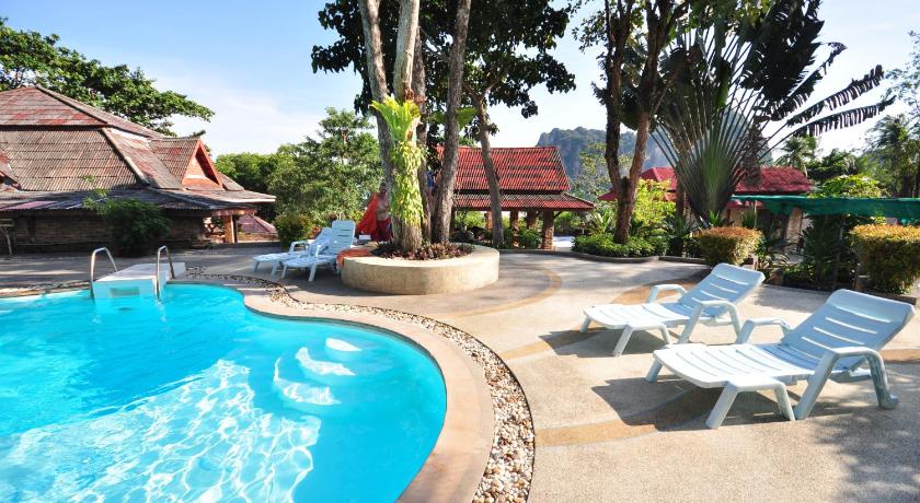 a beach with a pool, chairs, and a pool table, Railay Viewpoint Resort in Krabi