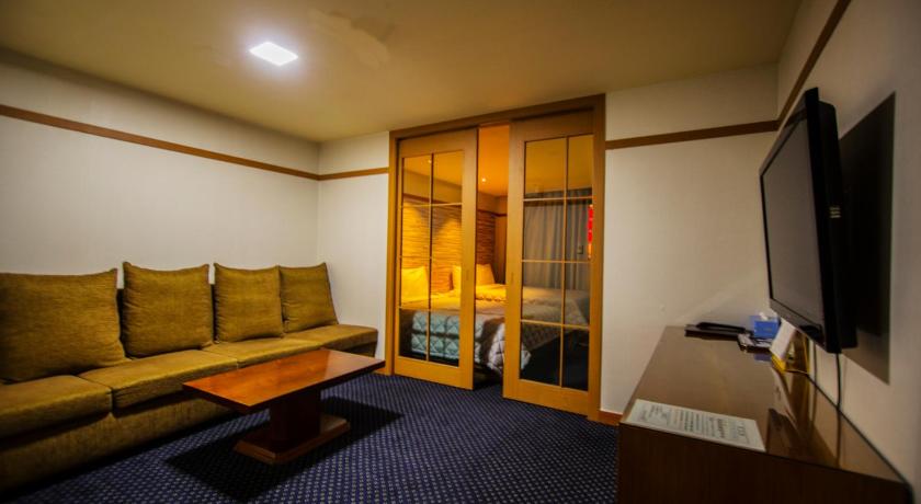a living room filled with furniture and a tv, Incheon Airport Hotel Zeumes in Incheon