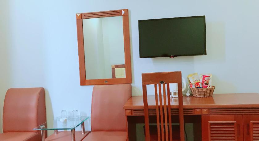 a living room filled with furniture and a tv, Hoang Ngoc Hotel in Pleiku (Gia Lai)