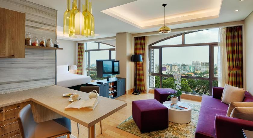 a living room filled with furniture and a tv, Sherwood Suites  in Ho Chi Minh City