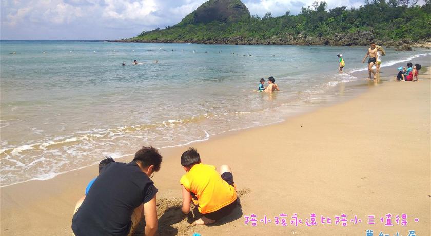 people standing on a beach with a surfboard, Dream House in Kenting