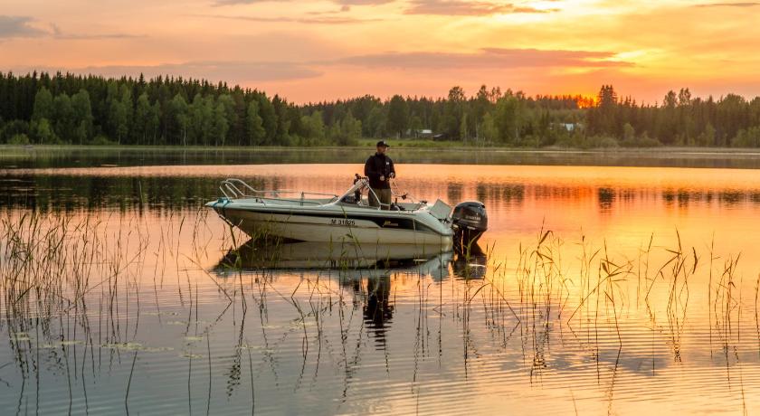 a man on a boat in the middle of a lake, Resort Naaranlahti in Punkaharju