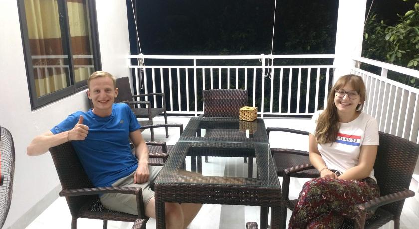 a woman sitting on a chair next to a man, Tuyet's Homestay in Ninh Bình