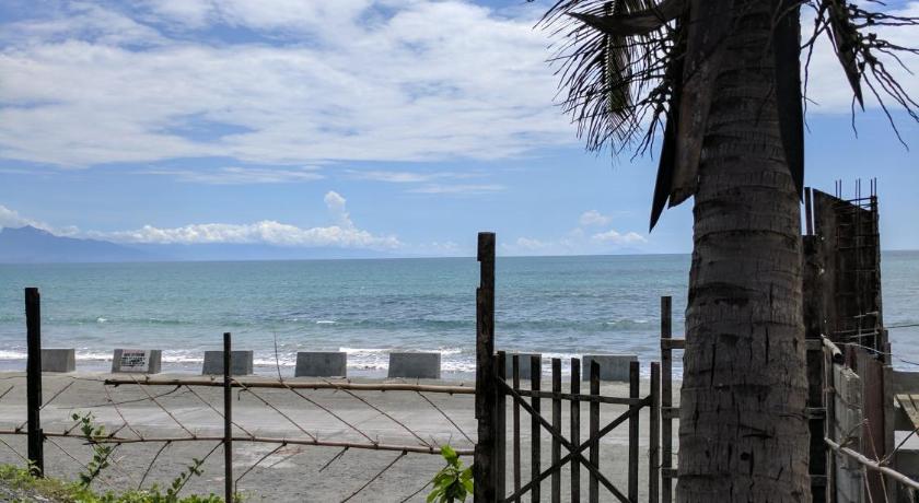 a beach with palm trees and palm trees, Baler Beachfront House in Baler