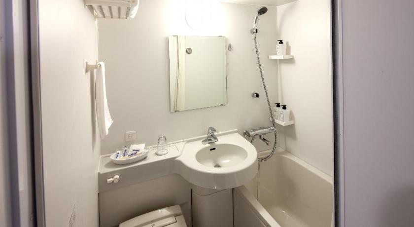 a bathroom with a sink, toilet, and shower, Y's Hotel Asahikawa in Asahikawa