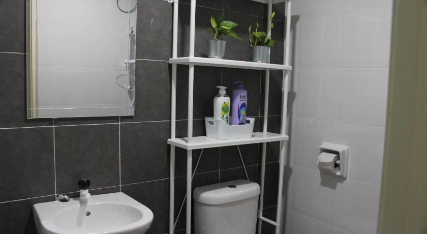 a bathroom with a toilet, sink, and mirror, Luxury Kuala Selangor Homestay in Kuala Selangor