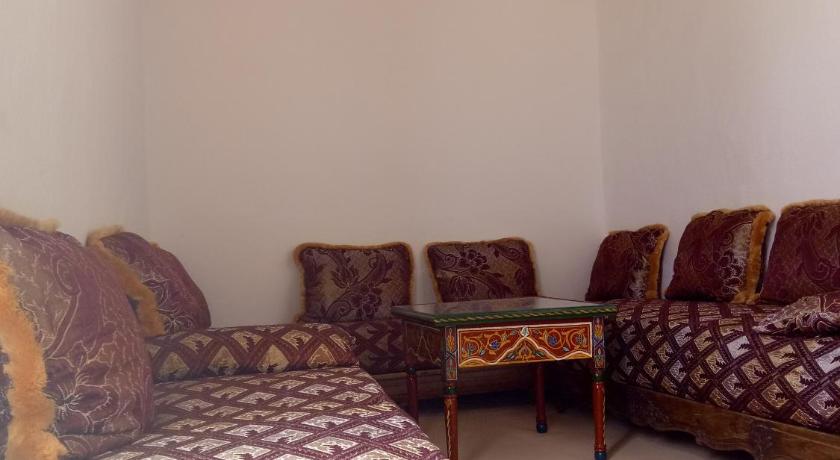 a room with a bed, chair, desk and a lamp, Maison Saadia in Rabat