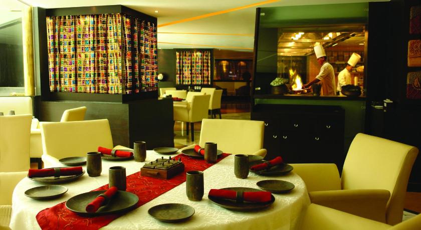 a dining room table with chairs and a table cloth, Sahara Star Hotel in Mumbai