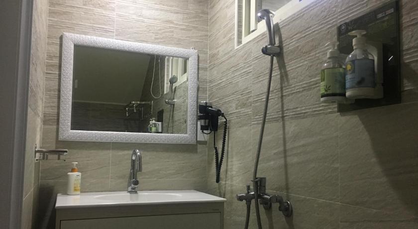 a bathroom with a sink and a mirror, Music Guest House in Kinmen Islands