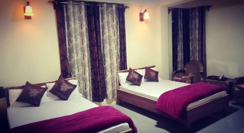 a hotel room with two beds and two lamps, Jms lodge in Cherrapunji