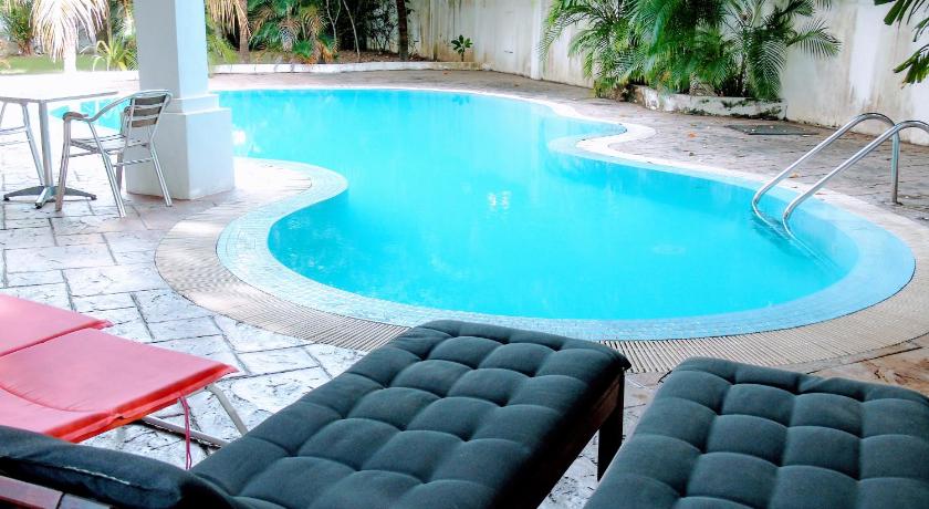 a pool with a couch and chairs in it, Rumah Putih B & B in Kuala Lumpur