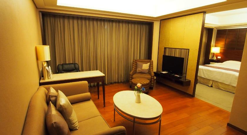 a living room filled with furniture and a fireplace, Elite Hotel in Miaoli