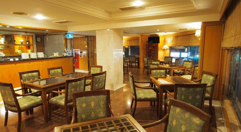 a dinning room with tables, chairs, and tables, Elite Hotel in Miaoli