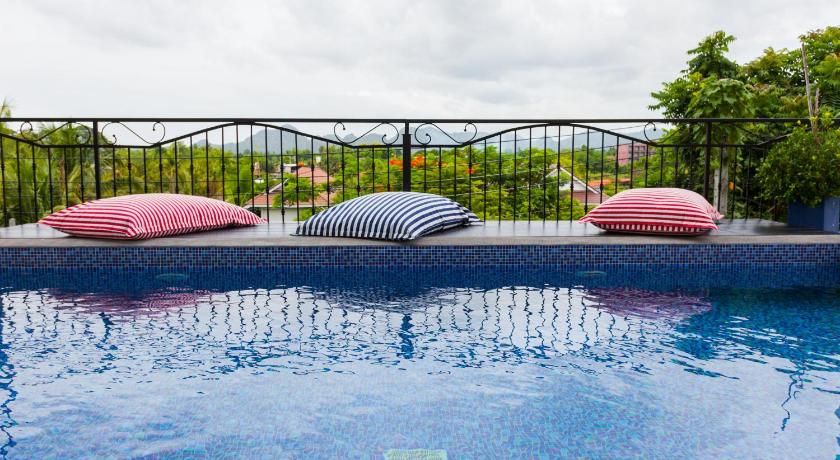 a pool with a couch and chairs in it, The Bridge Residence Hotel (SHA Extra Plus) in Kanchanaburi