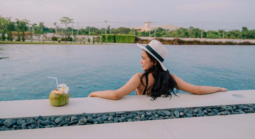a woman sitting on the edge of a pool of water, GreenVille Laguna Hotel (SHA Plus+) in Nakhonratchasima