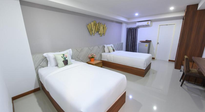 a hotel room with two beds and a desk, wish hotel ubon in Ubon Ratchathani